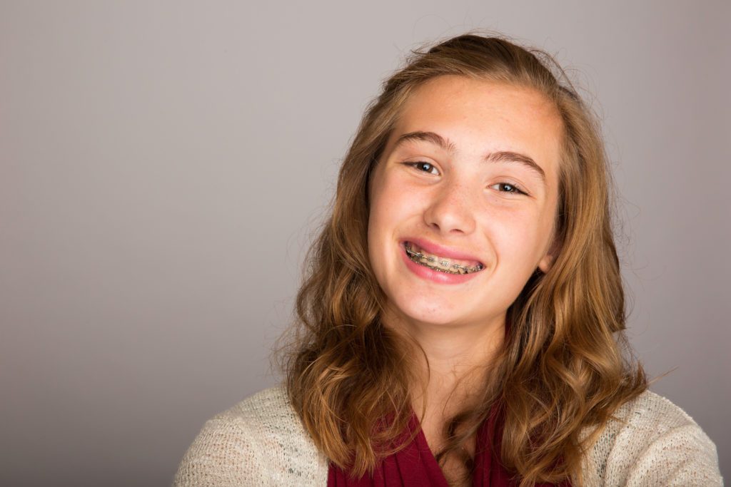 teen with braces smiling