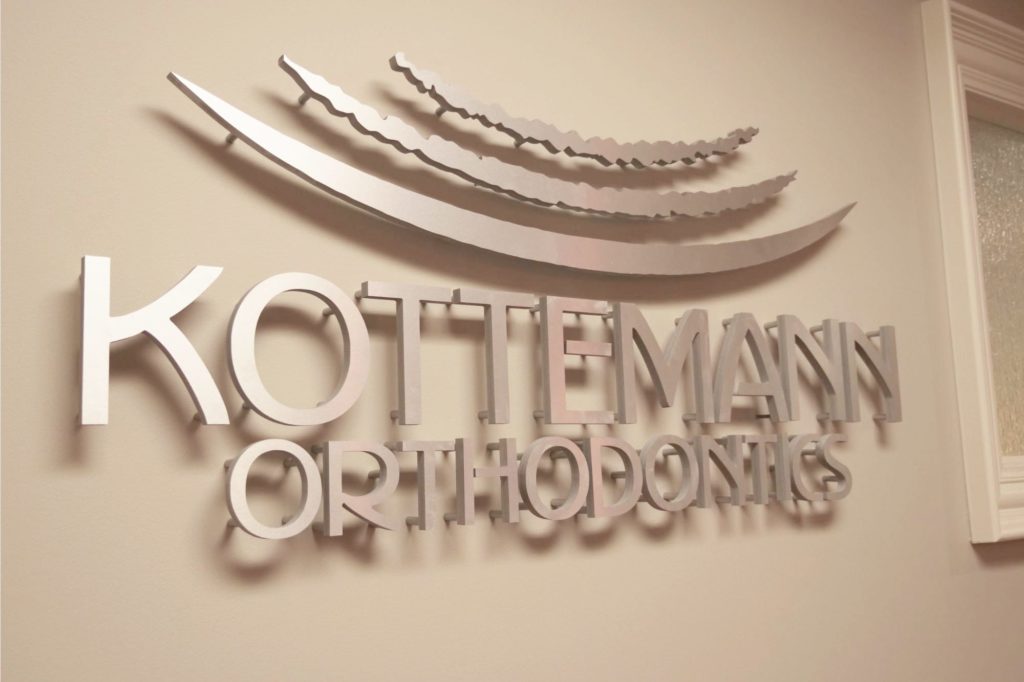 Kottemann Orthodontics logo on wall